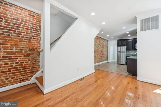 a view of empty room with a kitchen