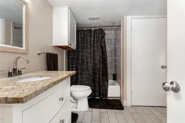 a bedroom with bed and a chandelier