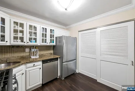 a kitchen with a refrigerator stove and sink