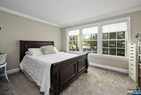 a spacious bedroom with a bed and a large window