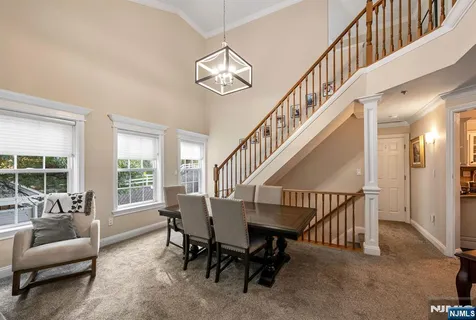 a living room with furniture and a dining table