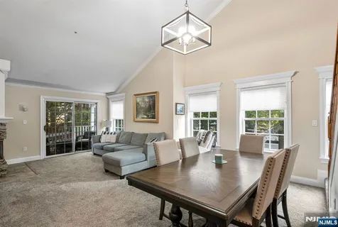 a view of a dining room with furniture wooden floor and chandelier