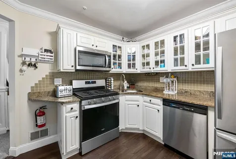a kitchen with stainless steel appliances granite countertop a stove and a sink