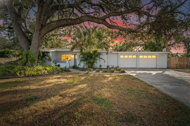a front view of a building with a yard and garage