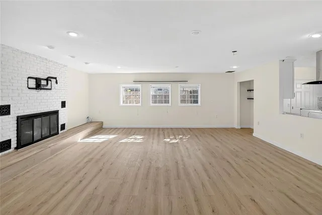 a kitchen with stainless steel appliances granite countertop a sink a stove and a wooden floors