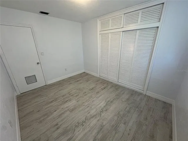 an empty room with wooden floor