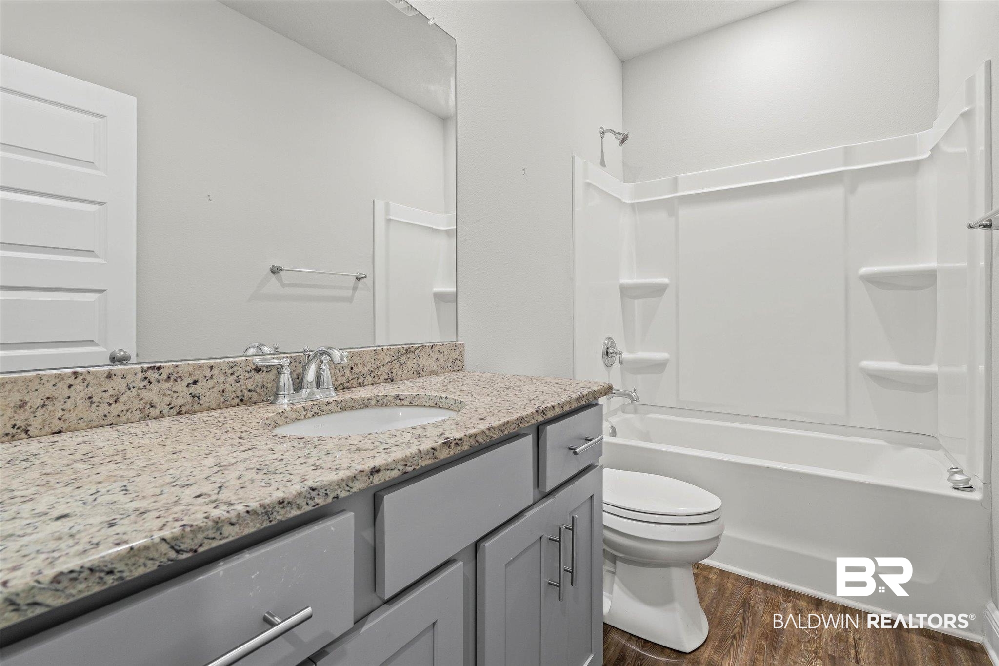 10207 Dunleith Loop Daphne, AL 36526 - Photo 12 of 23 Full bath with vanity, shower combination, and dark wood-type flooring