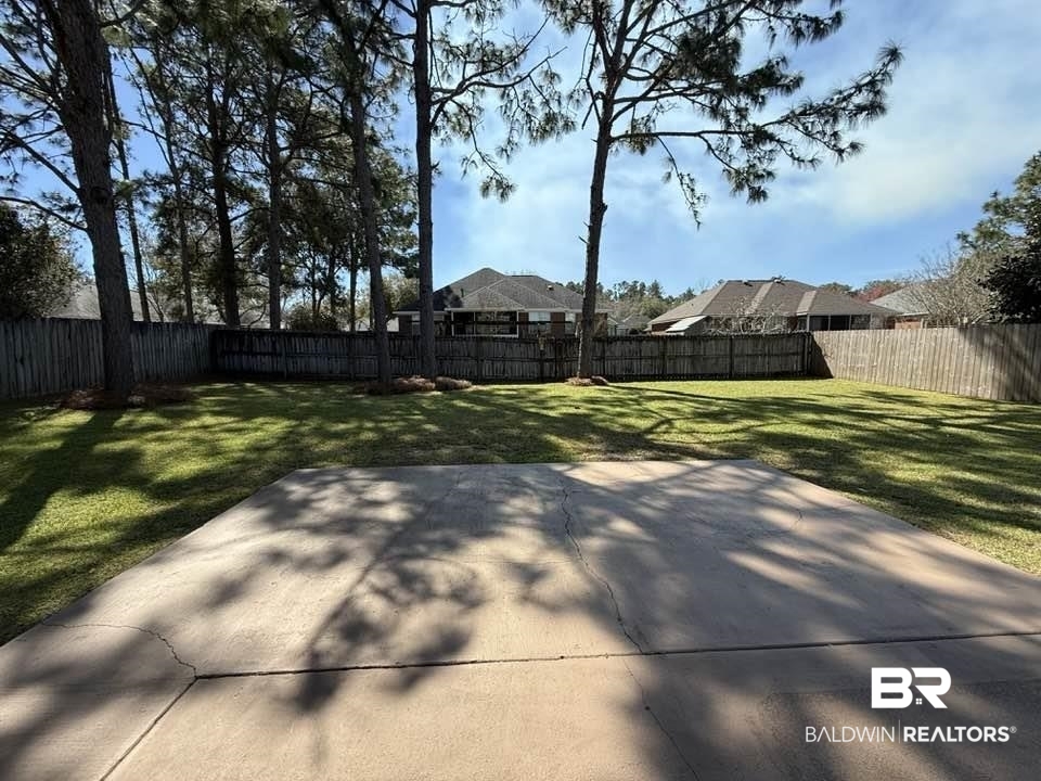10428 South Side Loop Fairhope, AL 36532 - Photo 3 of 28 View of yard with a patio area and a fenced backyard