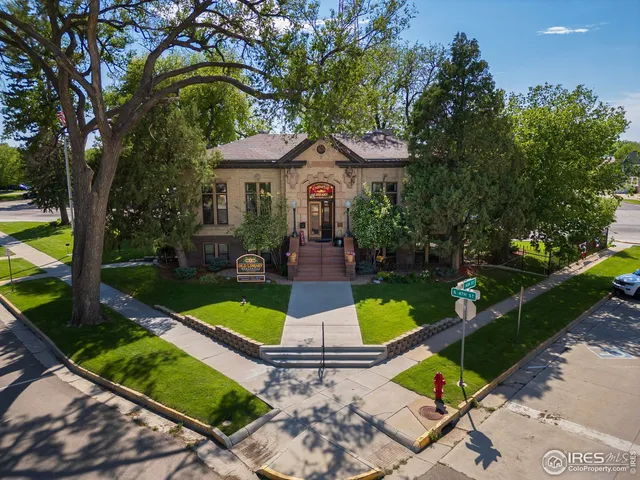 an aerial view of a house with swimming pool garden and patio