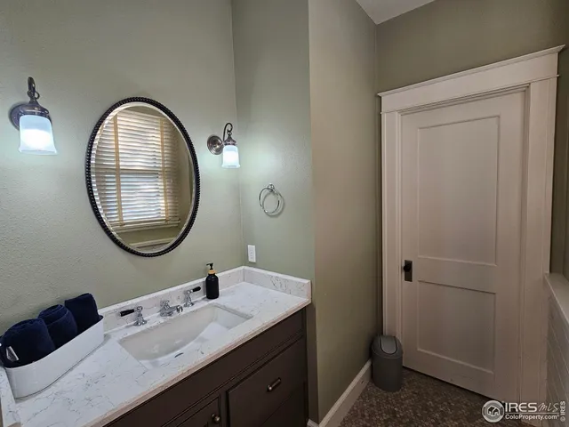a bathroom with a toilet a sink and a mirror
