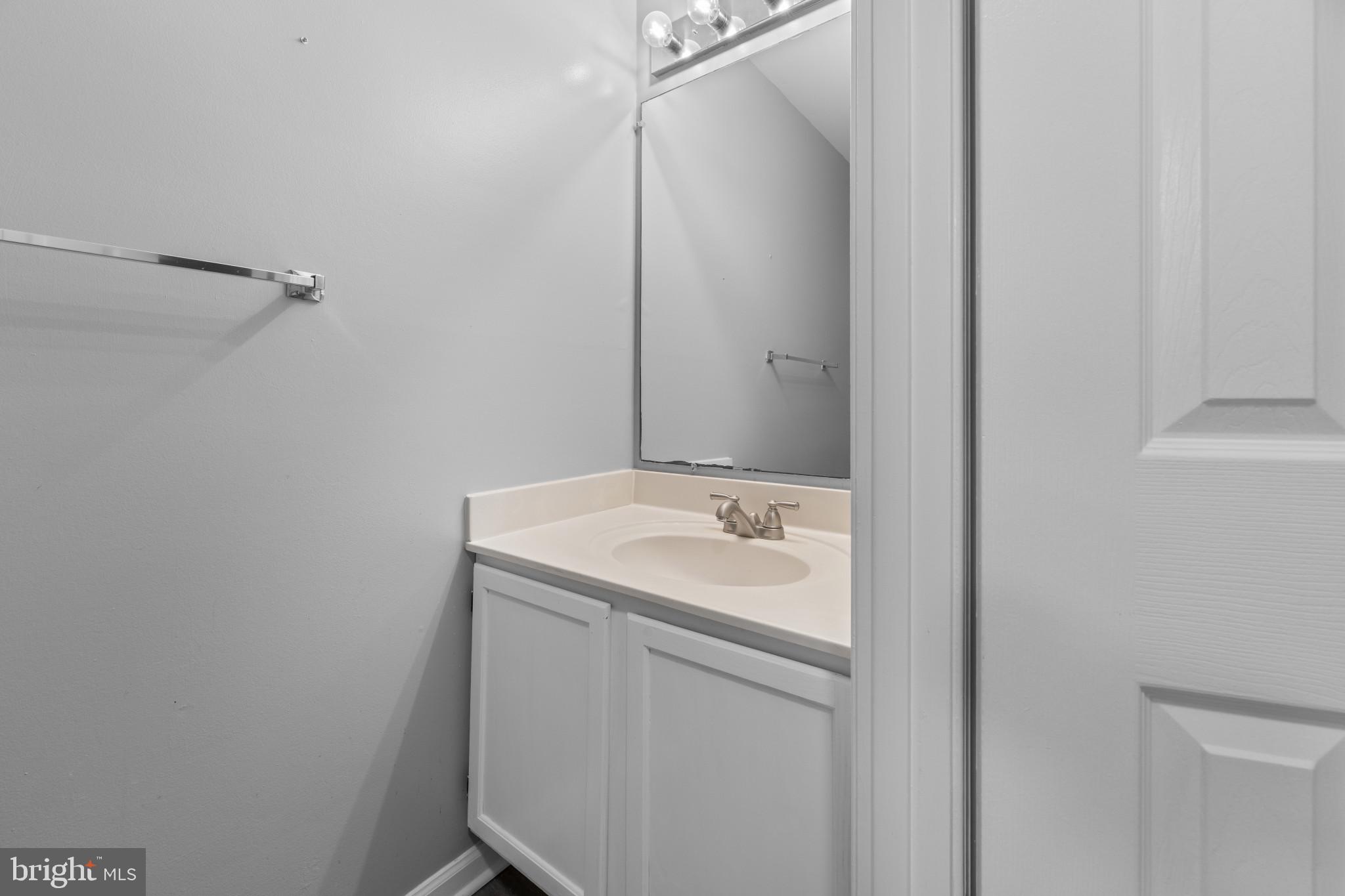 9302 Player Drive, Unit 155 Laurel, MD 20708 - Photo 19 of 43 a bathroom with a sink and mirror