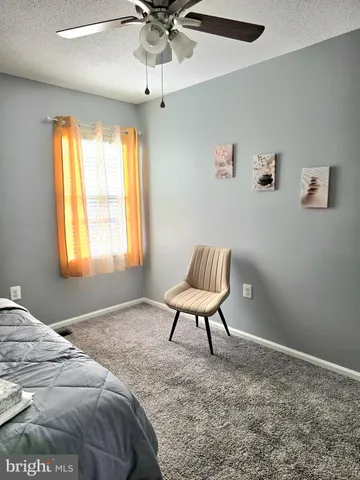 a bedroom with a bed and a chair