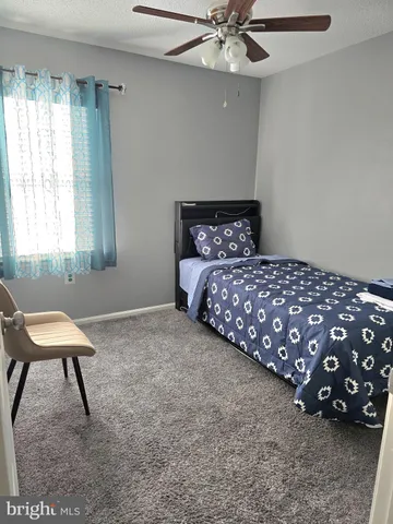 a bedroom with a bed and a chair