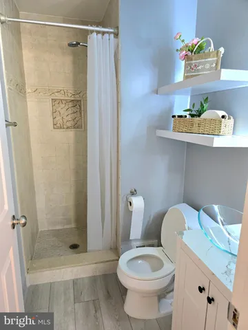 a bathroom with a shower a toilet and a shower