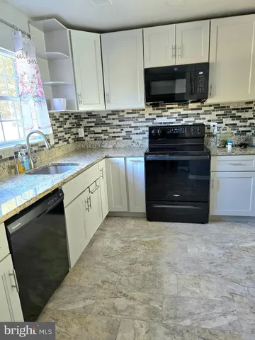 a kitchen with a stove and a sink