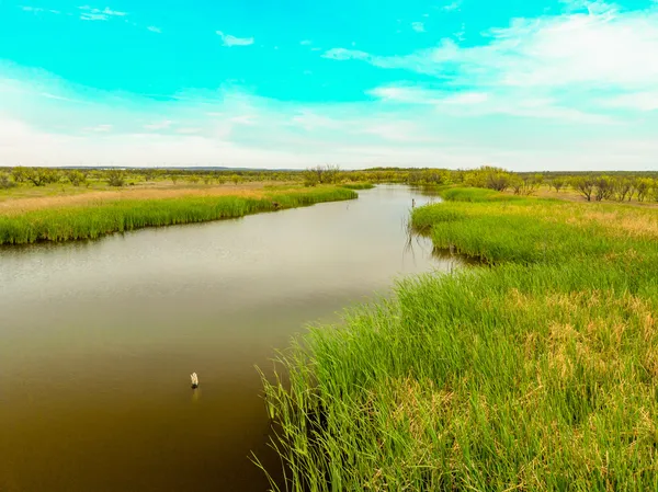 a view of a lake with houses in the background