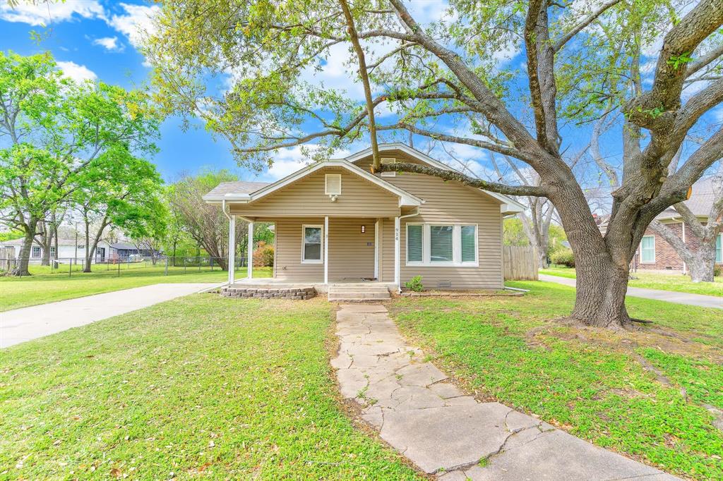 914 Prairie Avenue Cleburne, TX 76033 - Photo 1 of 19 a front view of a house with yard and green space
