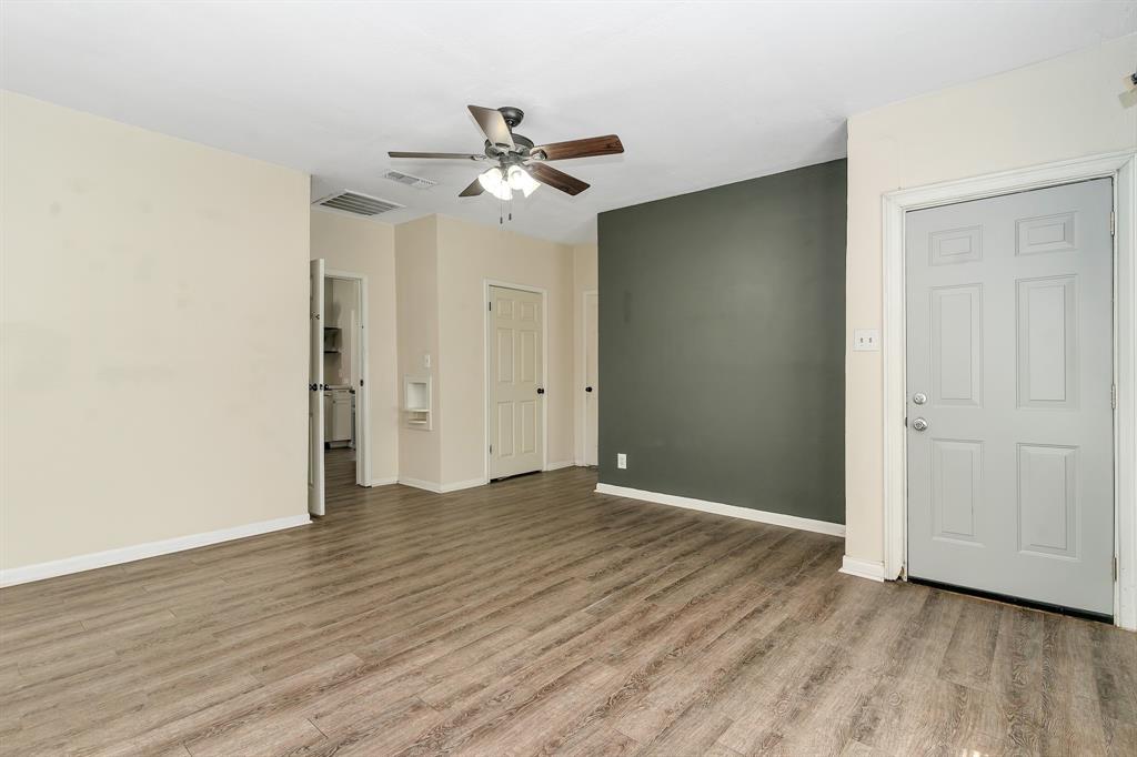 914 Prairie Avenue Cleburne, TX 76033 - Photo 12 of 19 an empty room with wooden floor closet and fan