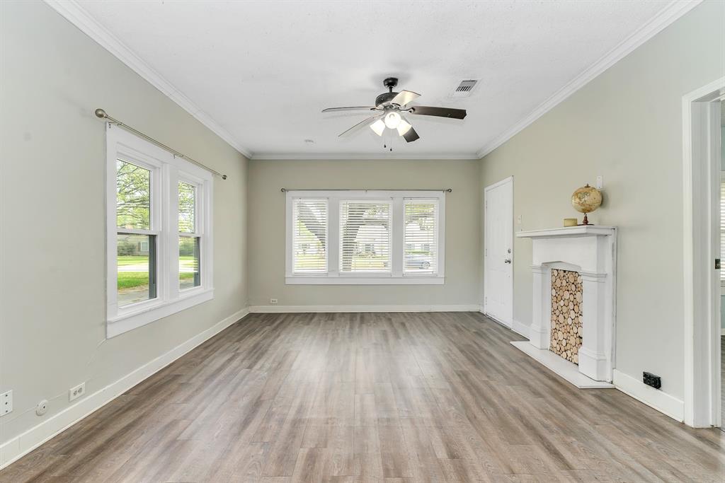 914 Prairie Avenue Cleburne, TX 76033 - Photo 6 of 19 a view of an empty room with a window and wooden floor