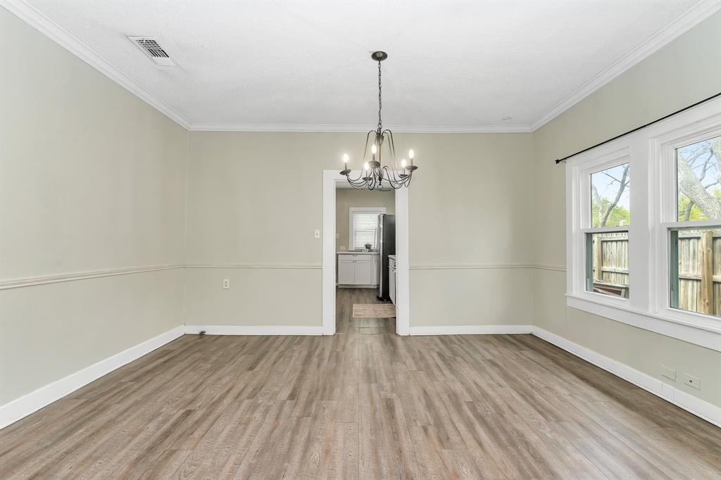 914 Prairie Avenue Cleburne, TX 76033 - Photo 7 of 19 an empty room with wooden floor and windows