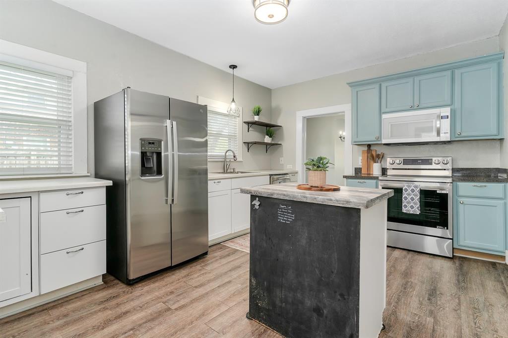 914 Prairie Avenue Cleburne, TX 76033 - Photo 10 of 19 a kitchen with white cabinets and stainless steel appliances