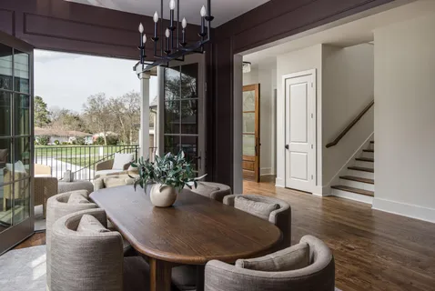 a dining room with furniture window and wooden floor
