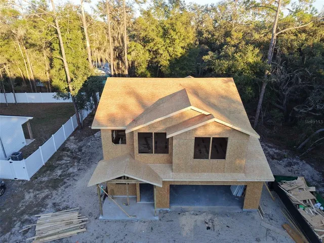a aerial view of a house with a yard