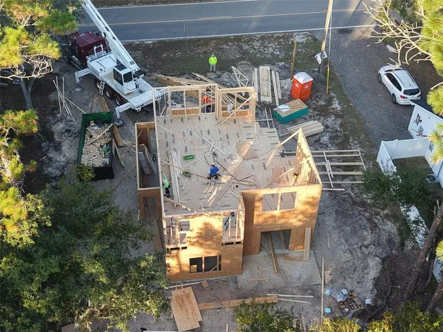 an aerial view of a house with a yard and potted plants