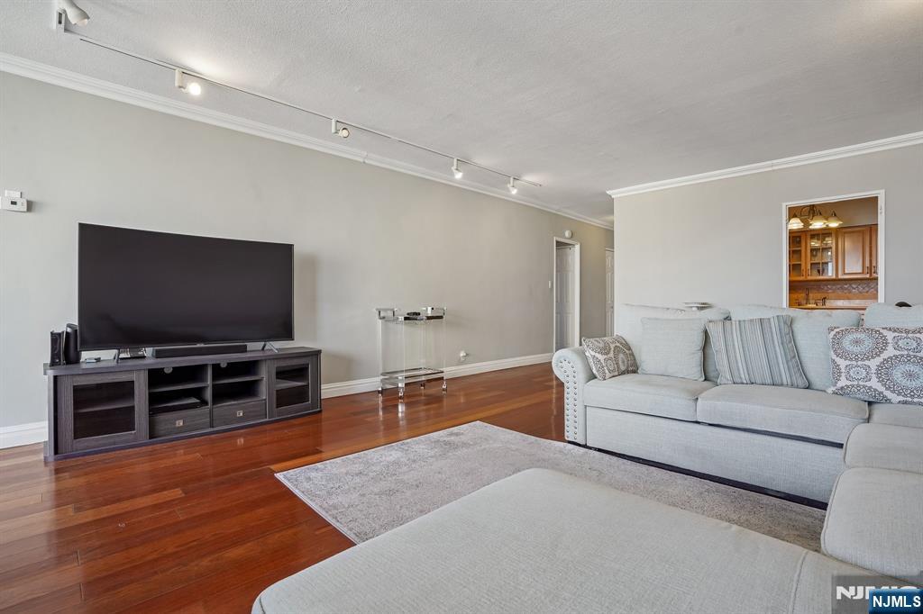 5 Horizon Road, Unit 2304 Fort Lee, NJ 07024 - Photo 12 of 33 a living room with furniture and a flat screen tv