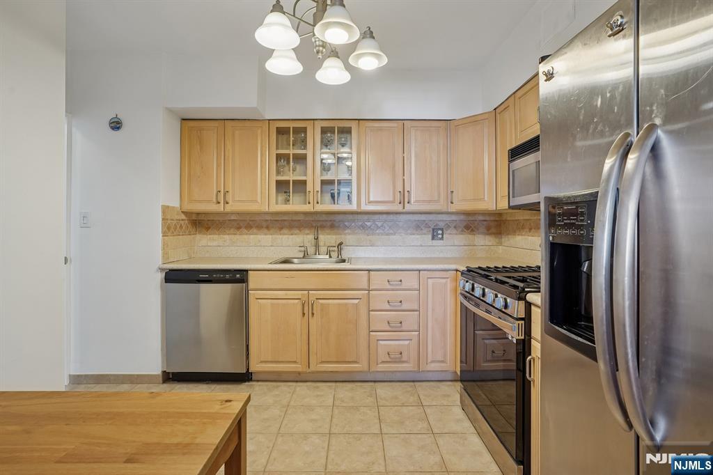5 Horizon Road, Unit 2304 Fort Lee, NJ 07024 - Photo 13 of 33 a kitchen with stainless steel appliances granite countertop a stove a sink and a refrigerator