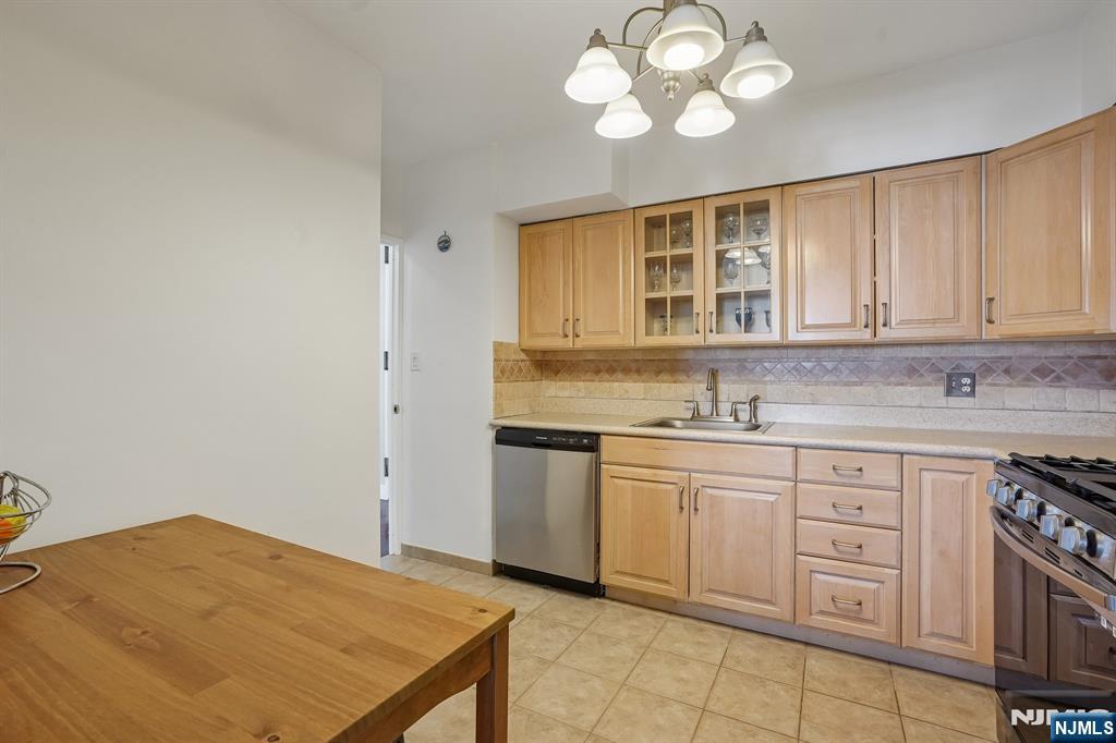 5 Horizon Road, Unit 2304 Fort Lee, NJ 07024 - Photo 14 of 33 a kitchen with a stove cabinets and a sink