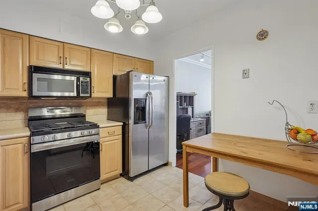 a kitchen with cabinets stainless steel appliances and a sink