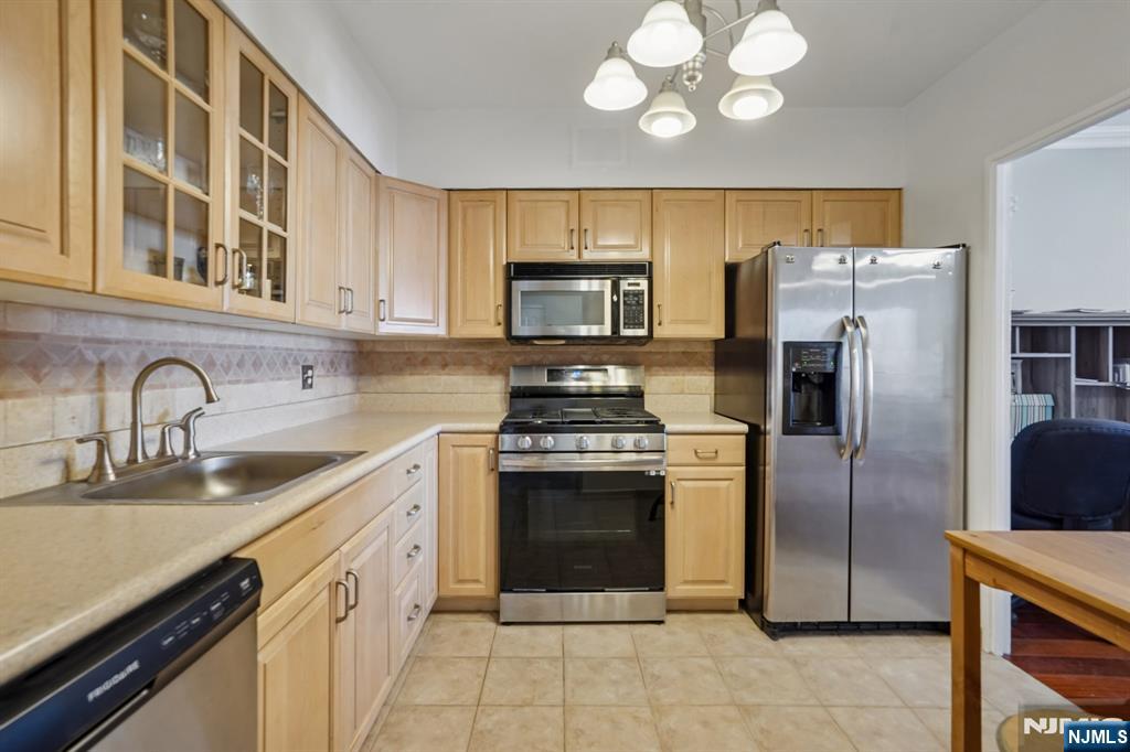 5 Horizon Road, Unit 2304 Fort Lee, NJ 07024 - Photo 17 of 33 a kitchen with stainless steel appliances granite countertop a stove a sink and a refrigerator