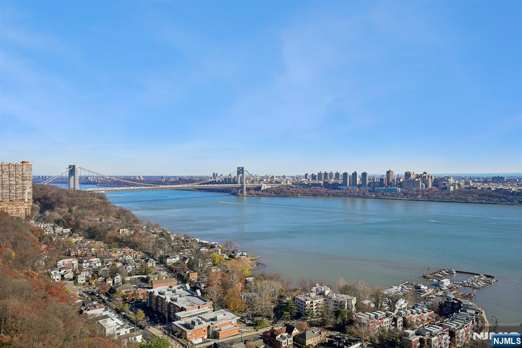 5 Horizon Road, Unit 2304 Fort Lee, NJ 07024 - Photo 20 of 33 a view of a lake with a mountain in the background