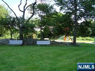 5 Horizon Road, Unit 2304 Fort Lee, NJ 07024 - Photo 29 of 33 a view of a wooden bench sitting in the grass