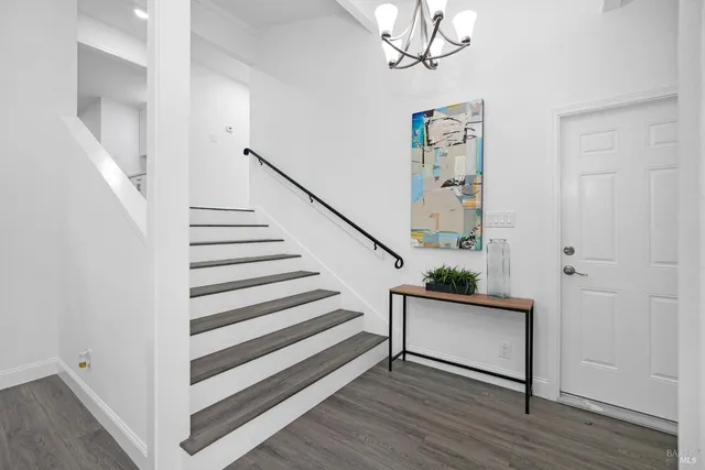 a view of entryway with wooden floor and stairs