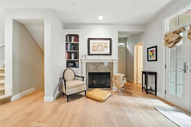 a view of entryway and hall with wooden floor