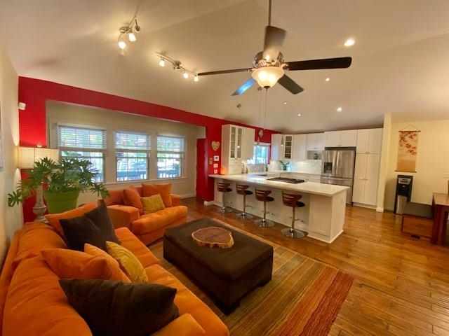 a living room with lots of furniture and kitchen view