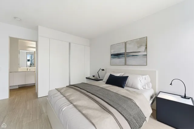 a bedroom with a bed and a painting