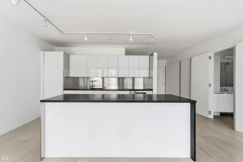 a kitchen with stainless steel appliances granite countertop a sink a stove and a refrigerator with wooden floor