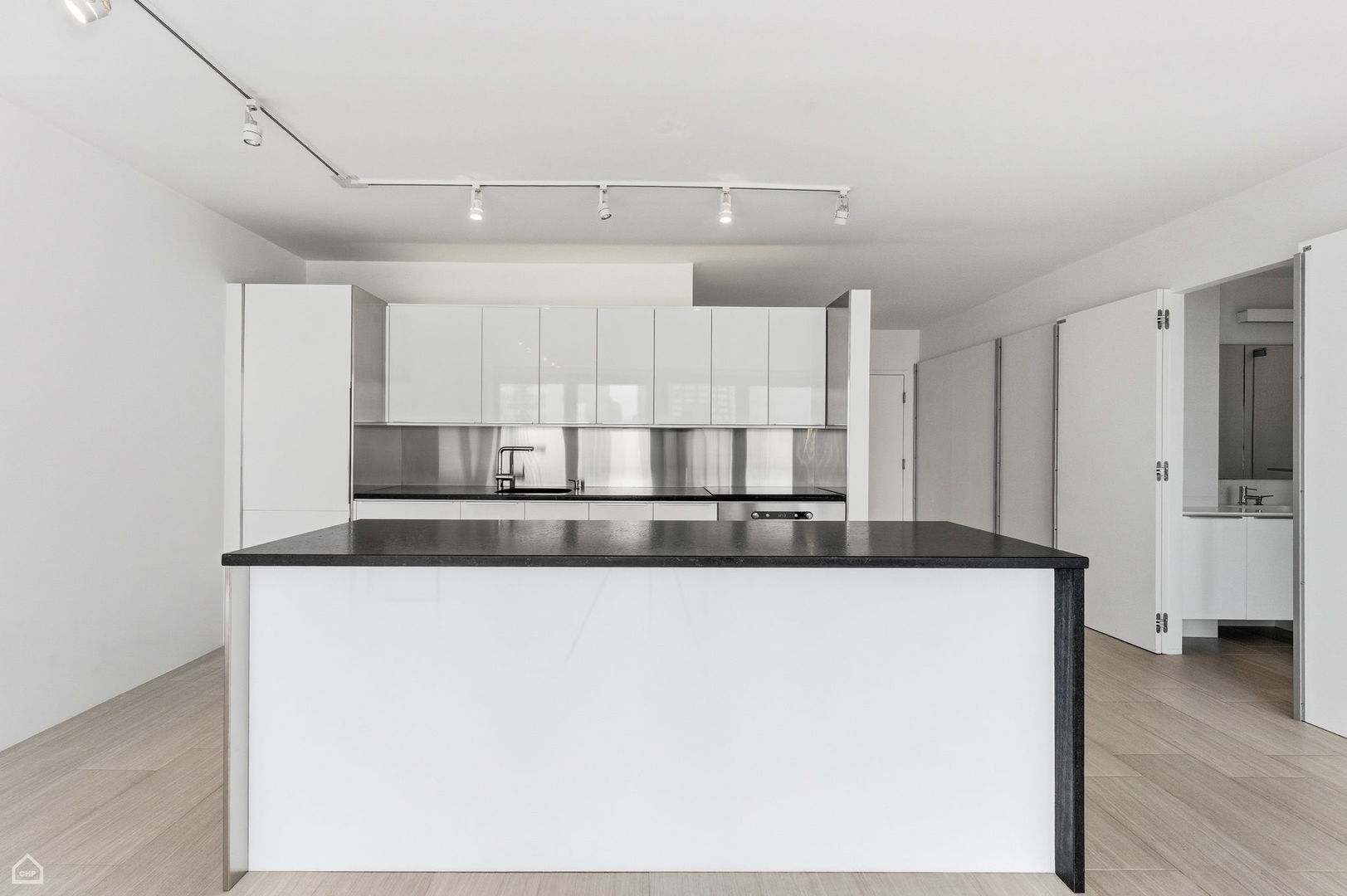 880 North Lake Shore Drive, Unit 22F Chicago, IL 60611 - Photo 10 of 21 a kitchen with stainless steel appliances granite countertop a sink a stove and a refrigerator with wooden floor