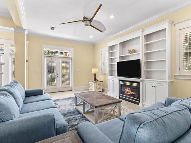 a living room with furniture a flat screen tv and a fireplace