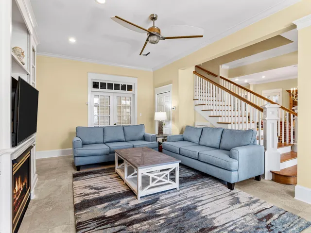 a living room with furniture ceiling fan and a rug