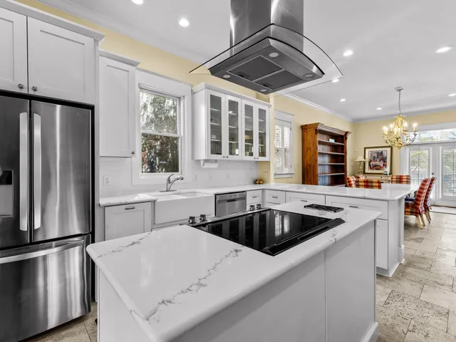 a kitchen with stainless steel appliances granite countertop a sink a stove and a refrigerator