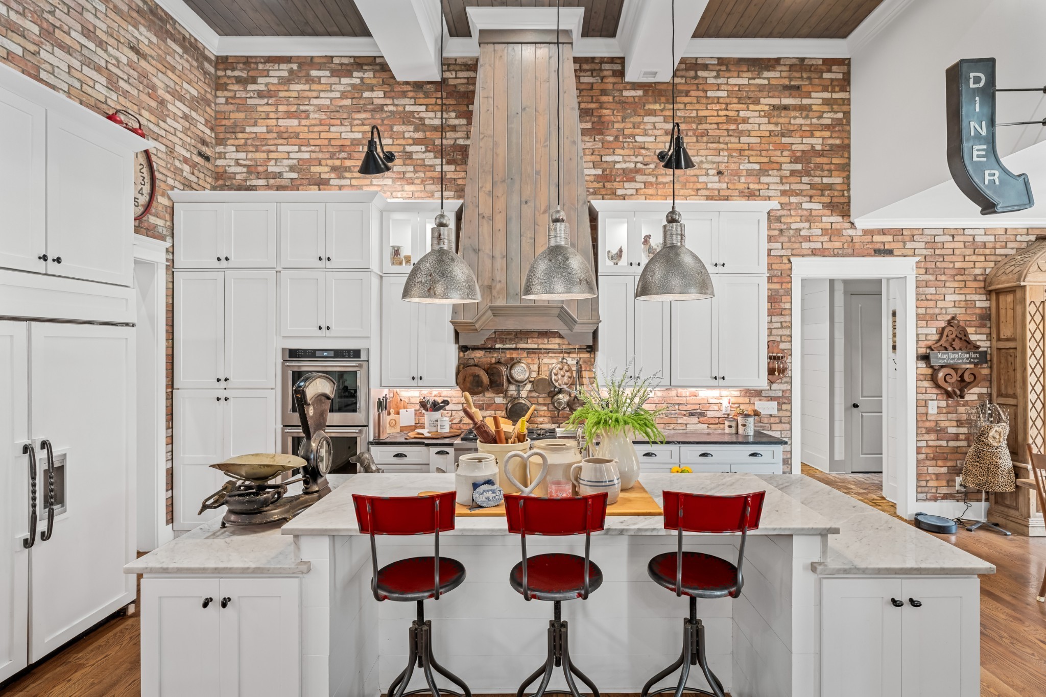5566 Hill Road Brentwood, TN 37027 - Photo 12 of 62 a kitchen with stainless steel appliances kitchen island granite countertop a stove and a refrigerator