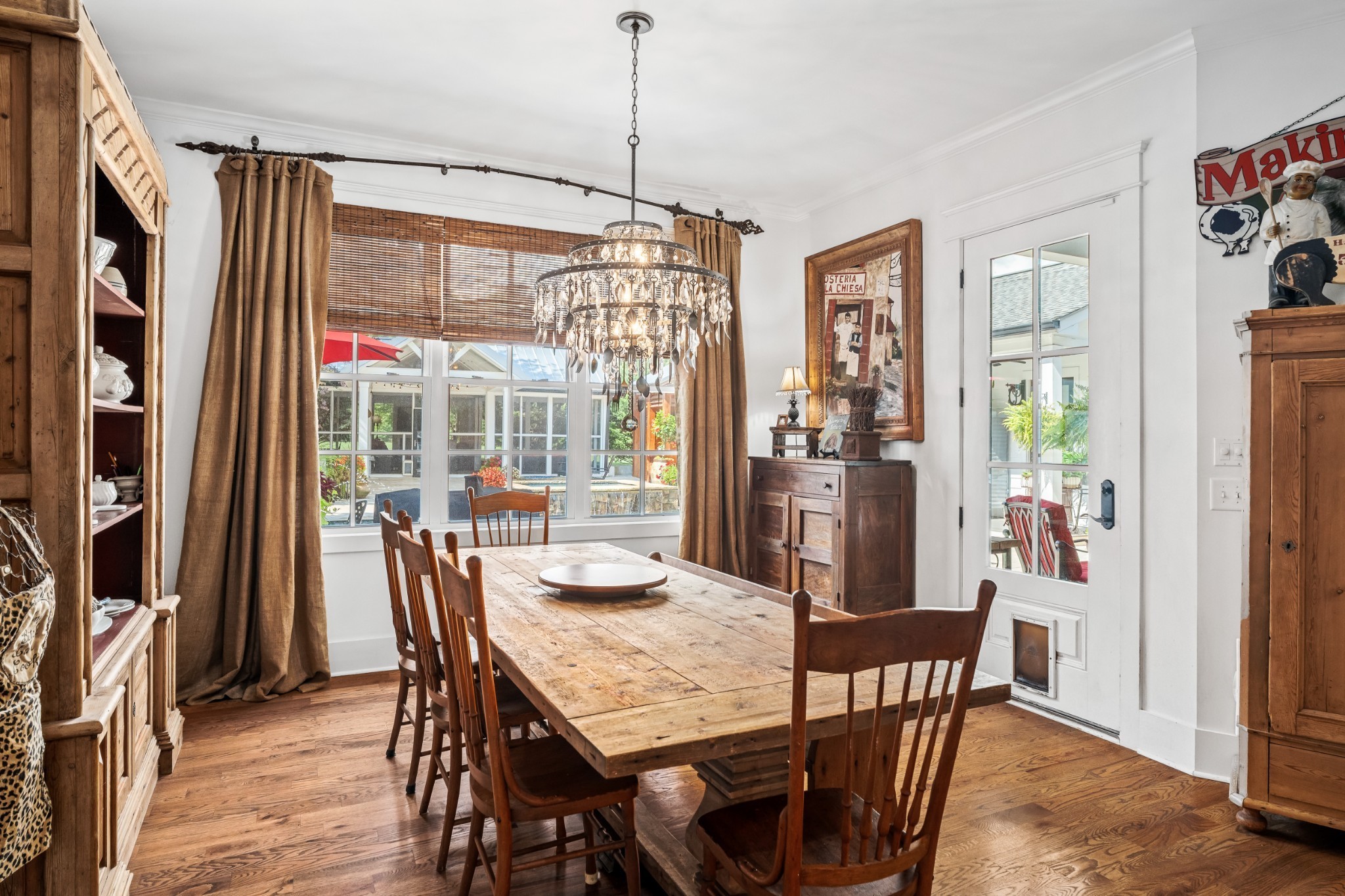 5566 Hill Road Brentwood, TN 37027 - Photo 15 of 62 a dining room with furniture a chandelier and wooden floor