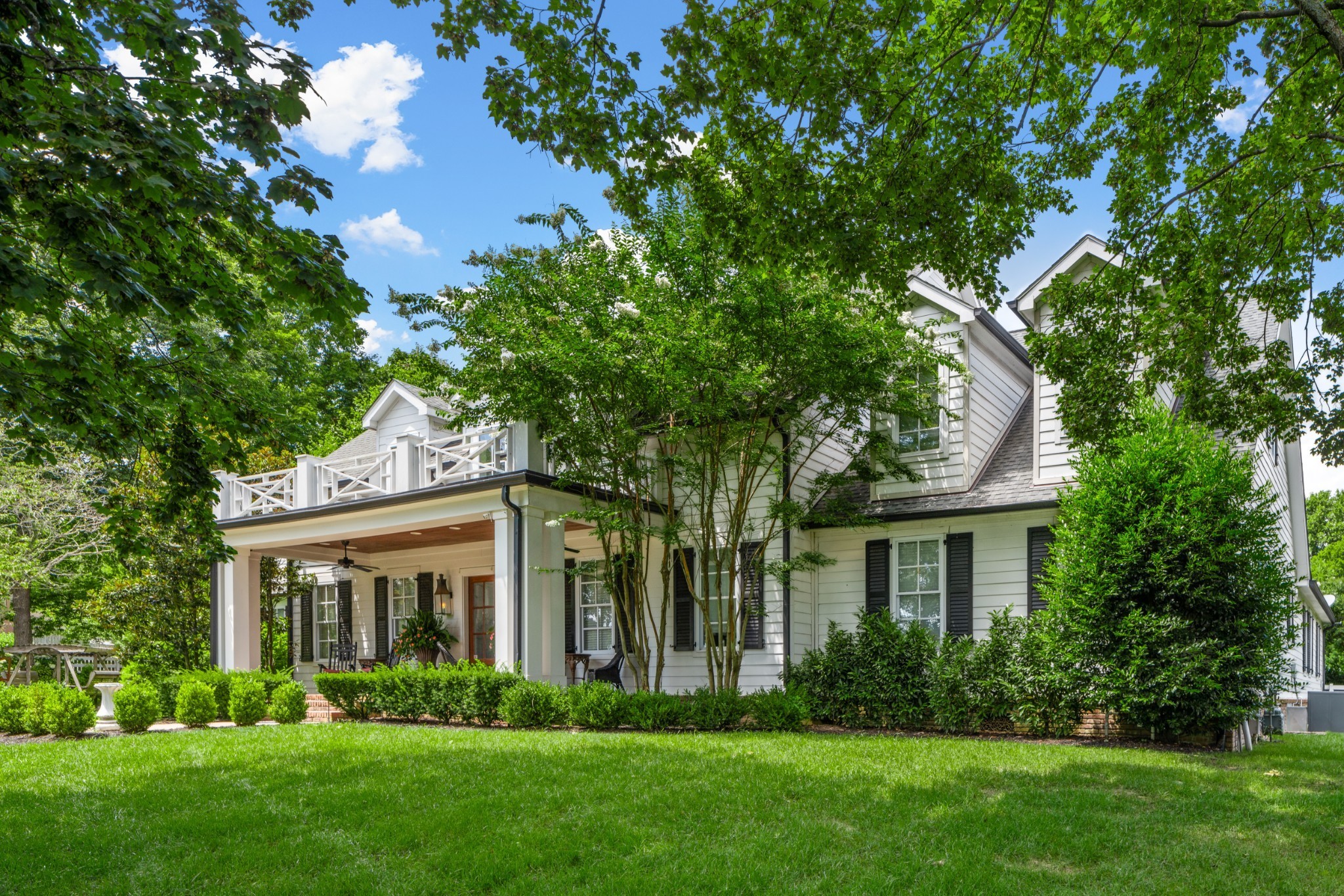 5566 Hill Road Brentwood, TN 37027 - Photo 2 of 62 a front view of a house with a garden and plants