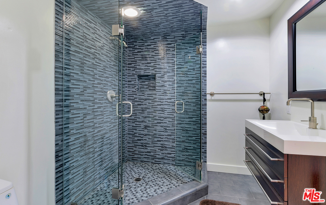 3921 Cody Road Sherman Oaks, CA 91403 - Photo 19 of 36 a bathroom with a sink and a shower