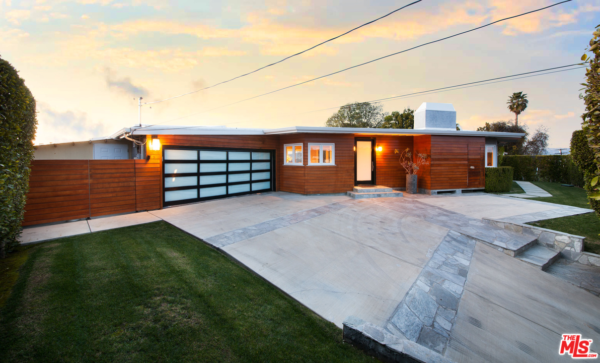 3921 Cody Road Sherman Oaks, CA 91403 - Photo 24 of 36 a front view of a house with a yard