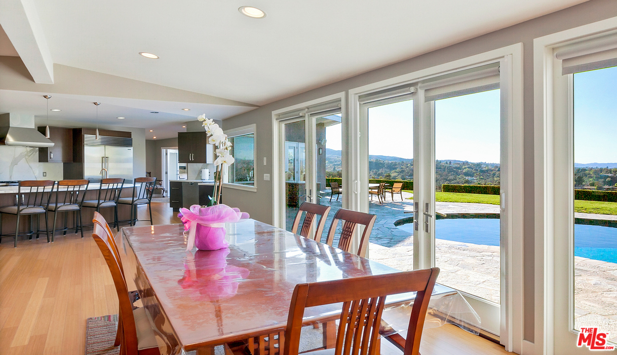 3921 Cody Road Sherman Oaks, CA 91403 - Photo 7 of 36 a view of a dining room with furniture large windows and wooden floor
